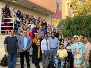 Group photo of several dozen facilitators at a GEP workshop in Iran. Dr. John Louis stands front and center.