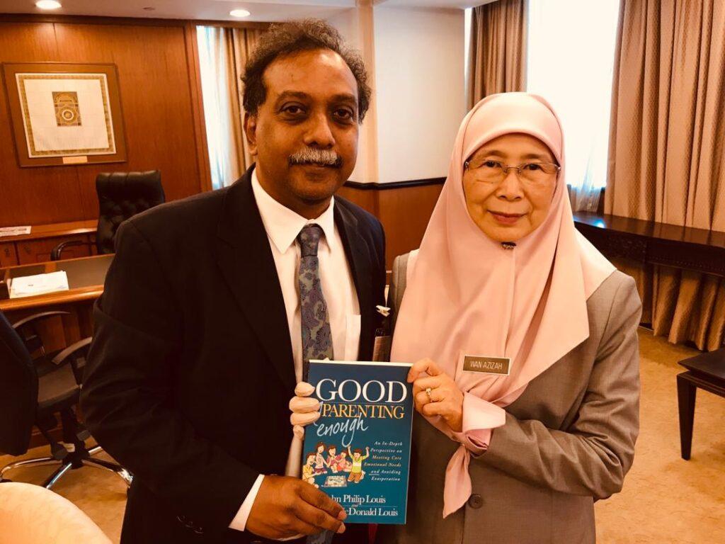 Dr. John Louis holding the first edition of the Good Enough Parenting book with Former Deputy Prime Minister of Malaysia Dato’ Seri Dr Wan Azizah binti Wan Ismail.
